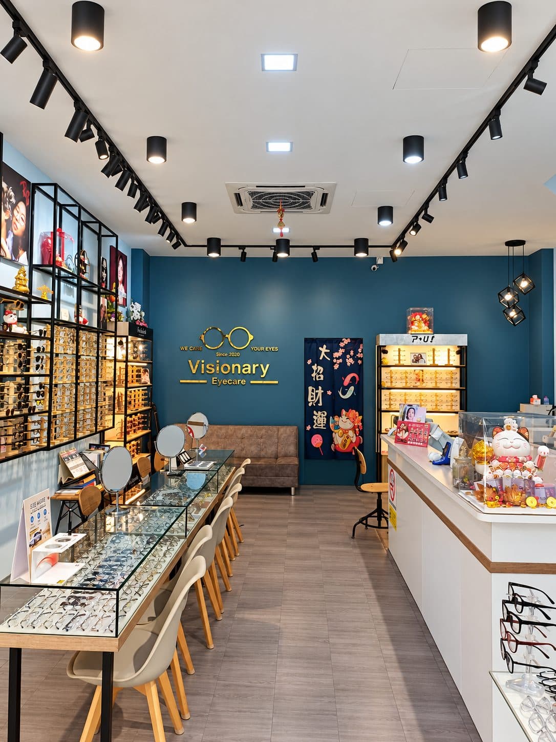 Inside Visionary Eyecare: frame shelves, glass counters and the navy logo wall
