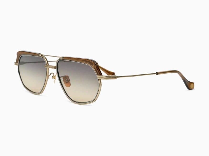 Gold navigator sunglasses with a brown brow bar and grey-to-amber gradient lenses